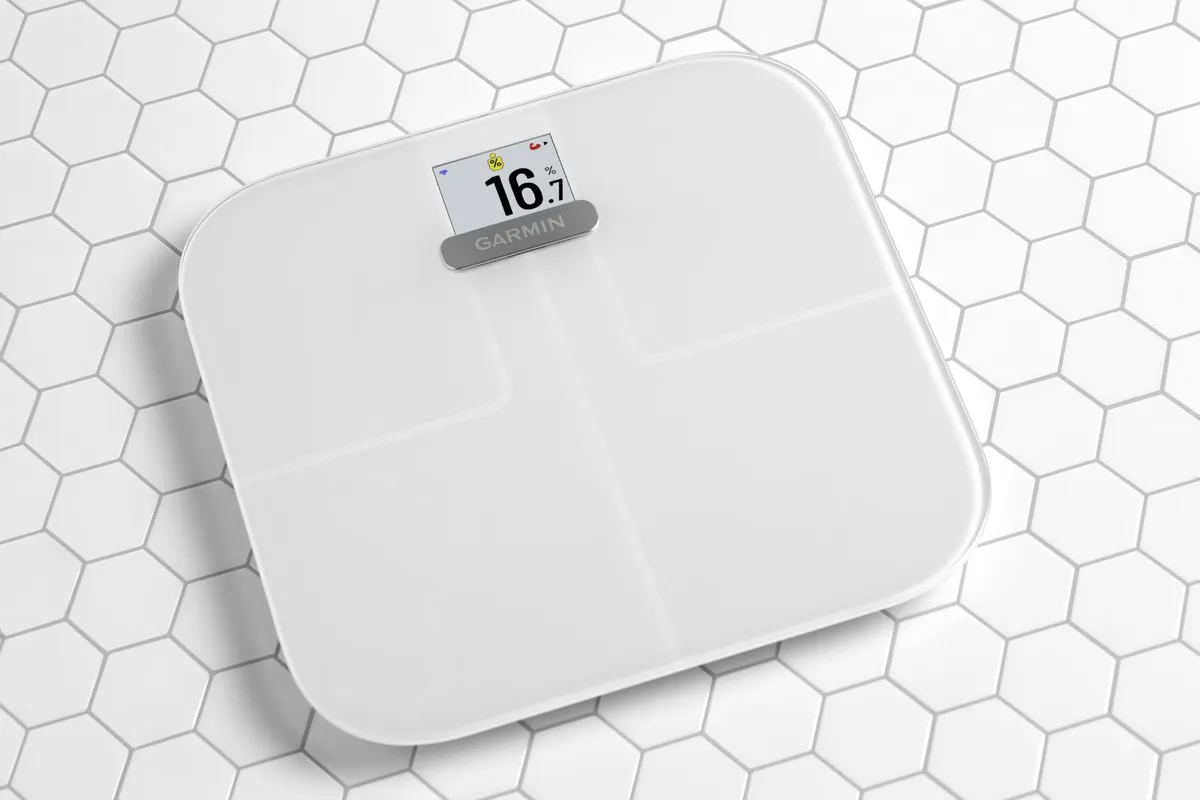 White Garmin Index S2 scale displaying a sample body-fat percentage of 16.7 percent